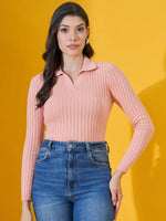 Woman in 98degreenorth’s Salmon Ribbed Collar Neck Sweater and blue jeans stands against a yellow background.
