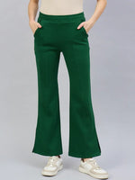 Model wears 98degreenorth Women’s Smiley Green Flared Bootcut Sweatpants with Side Slit, hands in pockets.