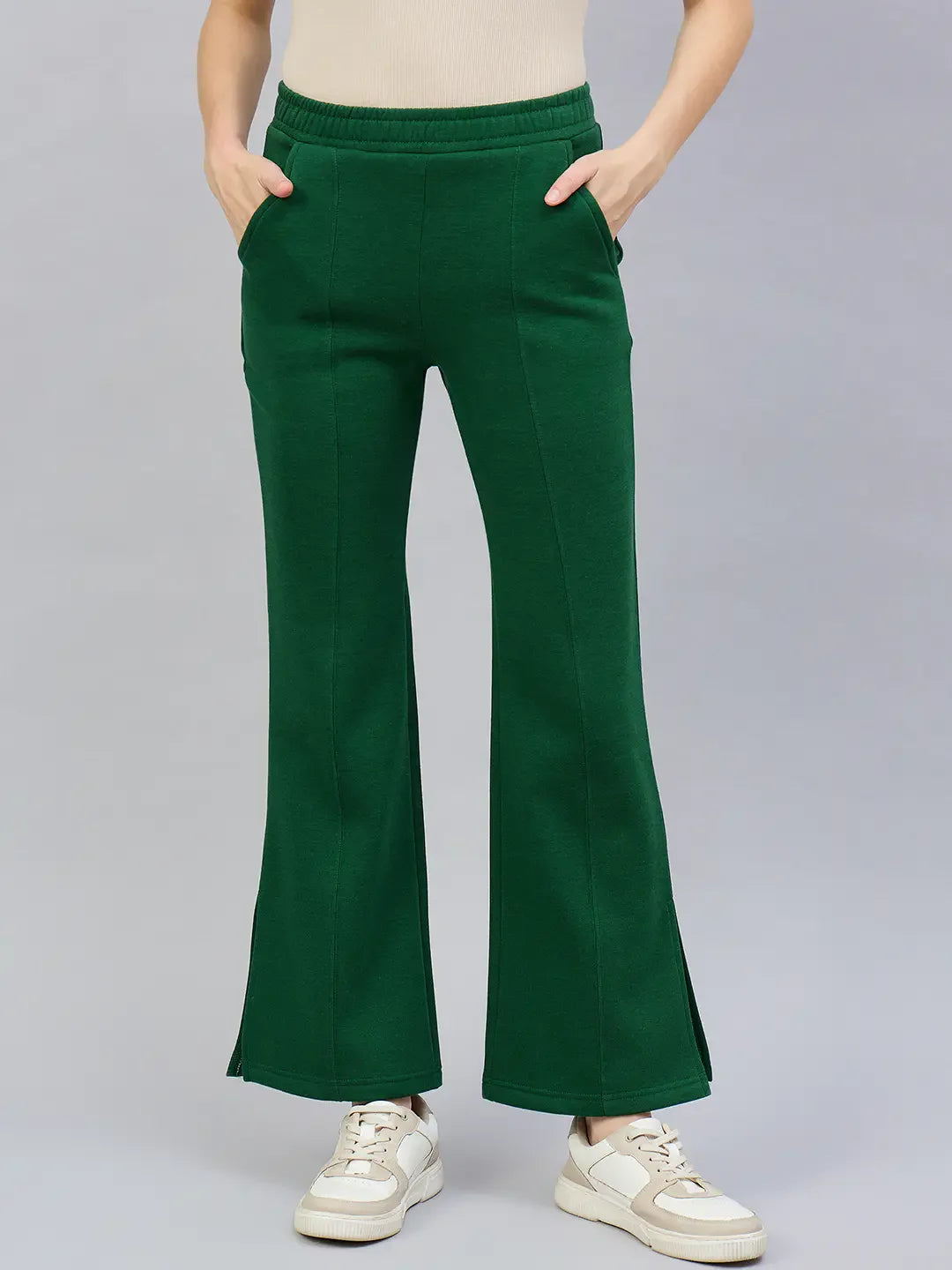 Model wears 98degreenorth Women’s Smiley Green Flared Bootcut Sweatpants with Side Slit, hands in pockets.