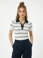 Model wears 98degreenorth Women's Striped Knit Polo Top - White & Navy with dark pants, hands in pockets.