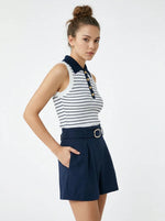 Woman in 98degreenorth's striped knit polo vest with collar and navy shorts channels nautical preppy style.