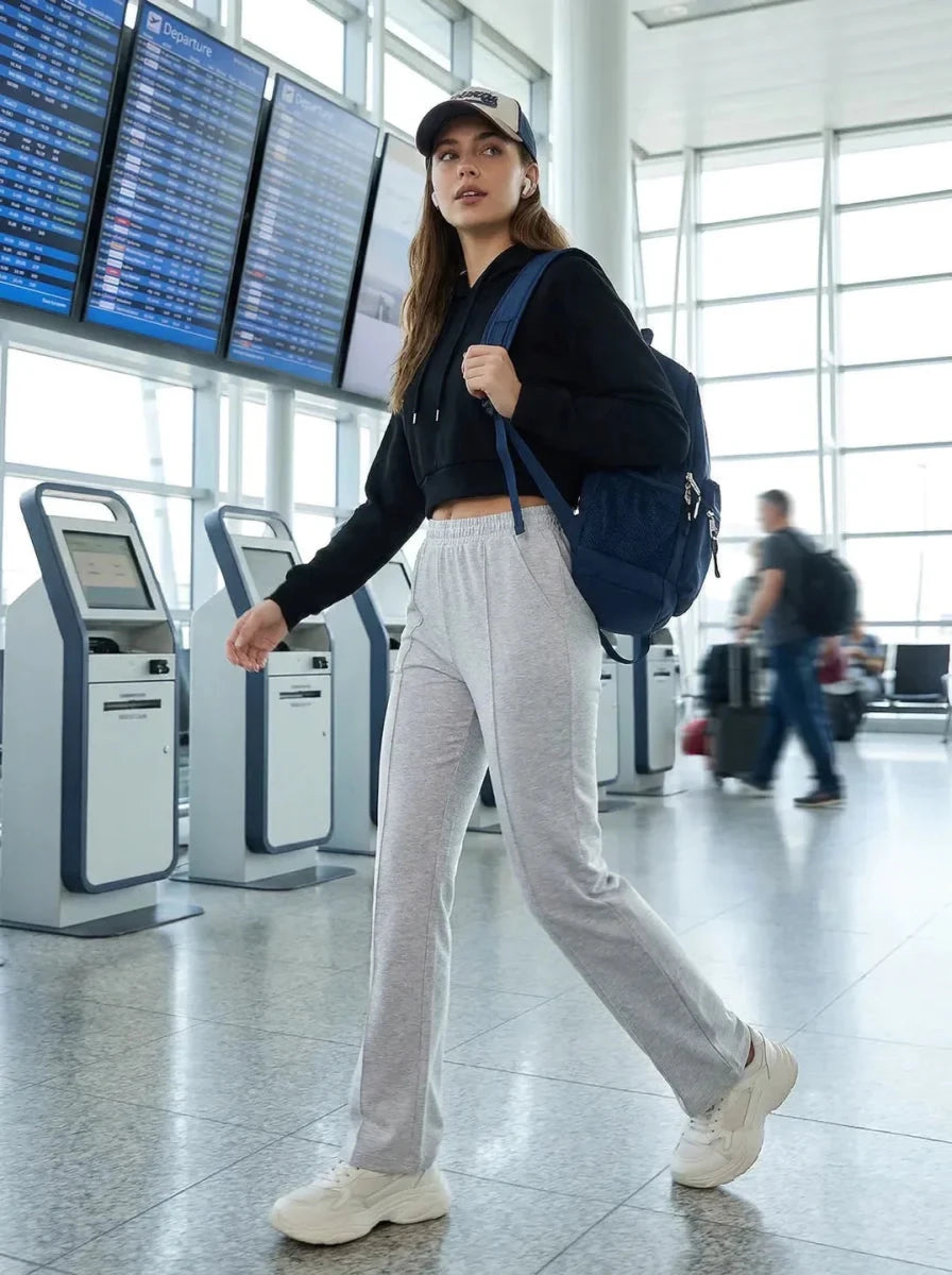 Woman at the airport in 98degreenorth Women's Tailored Straight Leg Pants in Light Grey – Premium Pintuck Trousers.