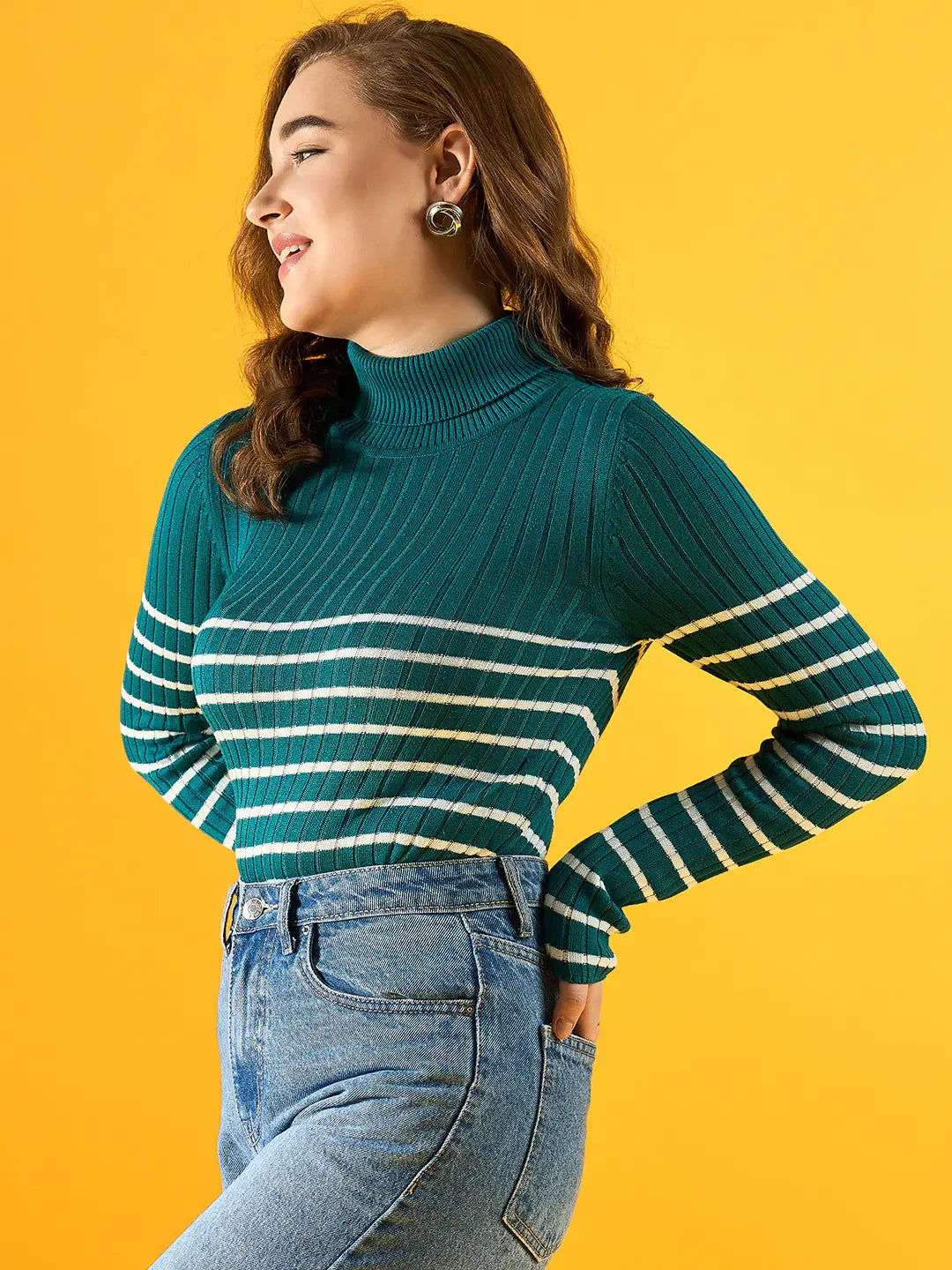Woman wears 98degreenorth’s Women’s Teal Ribbed Knit Turtleneck Sweater, smiling against a yellow background.