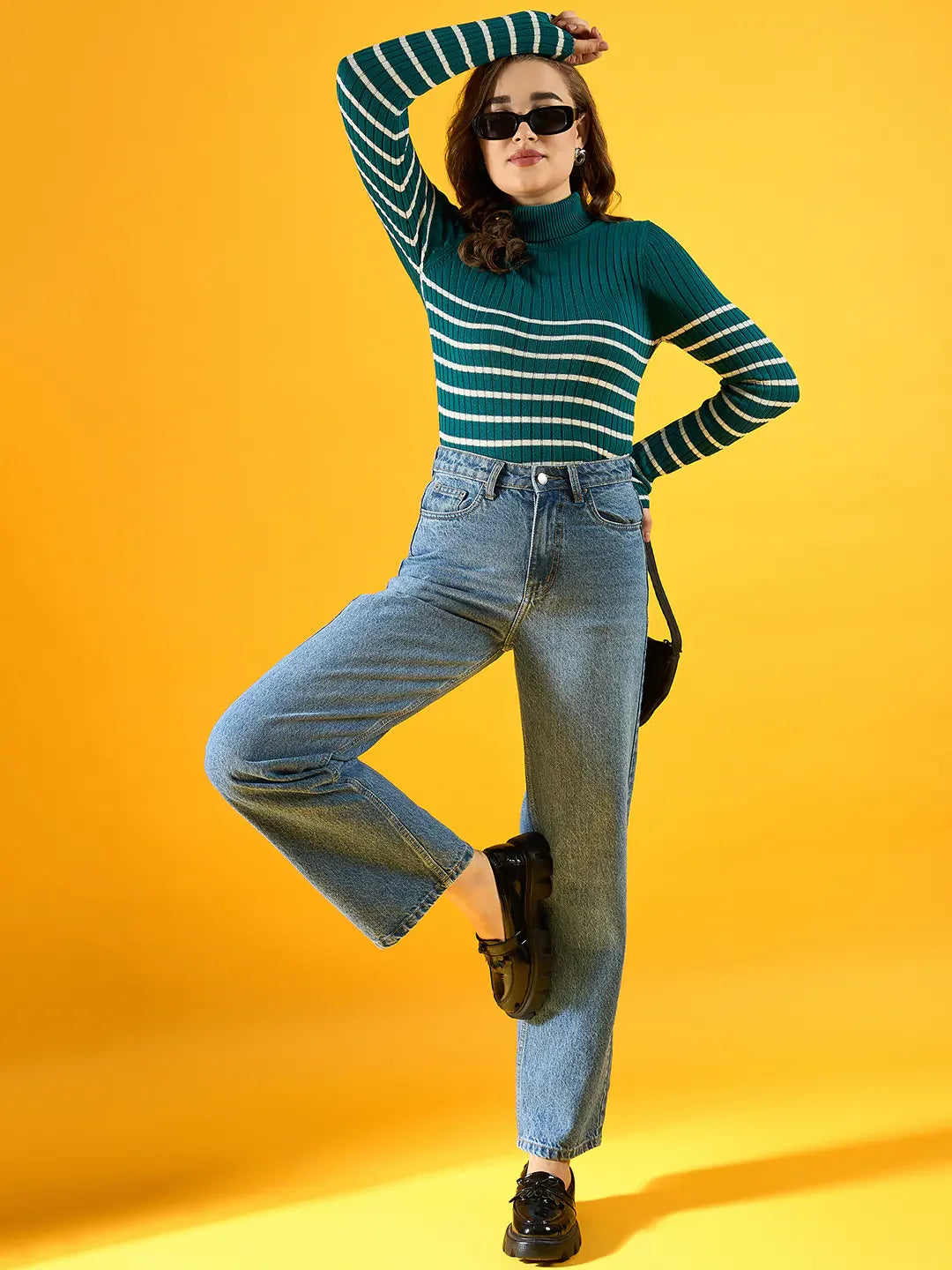Woman in sunglasses wears 98degreenorth Women's Teal Ribbed Knit Turtleneck Sweater, blue jeans, and black shoes.