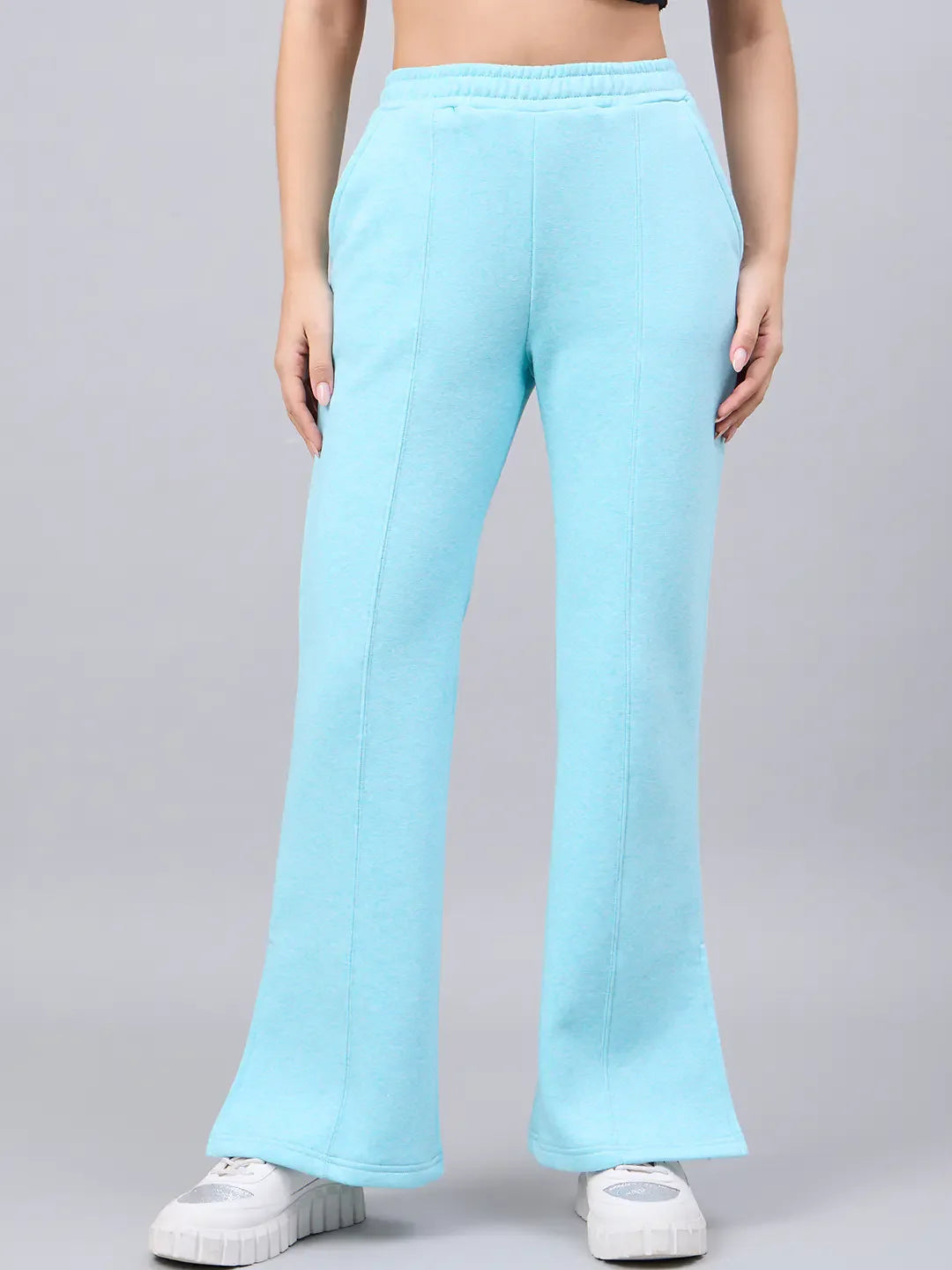 Model wears 98degreenorth Women's Turquoise Flared Bootcut Sweatpants with Side Slit, paired with white sneakers.