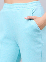 A woman wears 98degreenorth Women’s Turquoise Flared Bootcut Sweatpants, showing the high waist and side pocket.