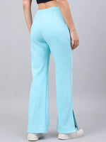 A person in 98degreenorth Women’s Turquoise Flared Bootcut Sweatpants, shown from the back against a plain background.