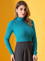 Woman in a 98degreenorth turquoise ribbed stretchable turtleneck sweater stands against a yellow backdrop.