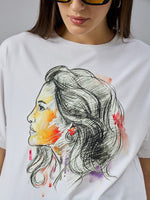 A woman in sunglasses and a white 98degreenorth Women’s Typography Cotton T-shirt with a colorful profile sketch.