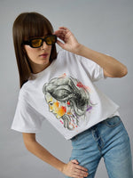 Woman in 98degreenorth Women’s Typography Cotton T-shirt, streetwear style, posing confidently with sunglasses.