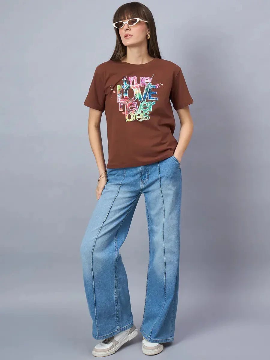 Woman wears 98degreenorth Women’s Typography Graphic Print Cotton Tee—Streetwear Essential—styled with wide-leg jeans.