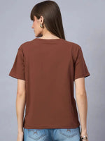 Woman with straight brown hair wears the 98degreenorth Women’s Typography Graphic Print Cotton Tee, facing away.