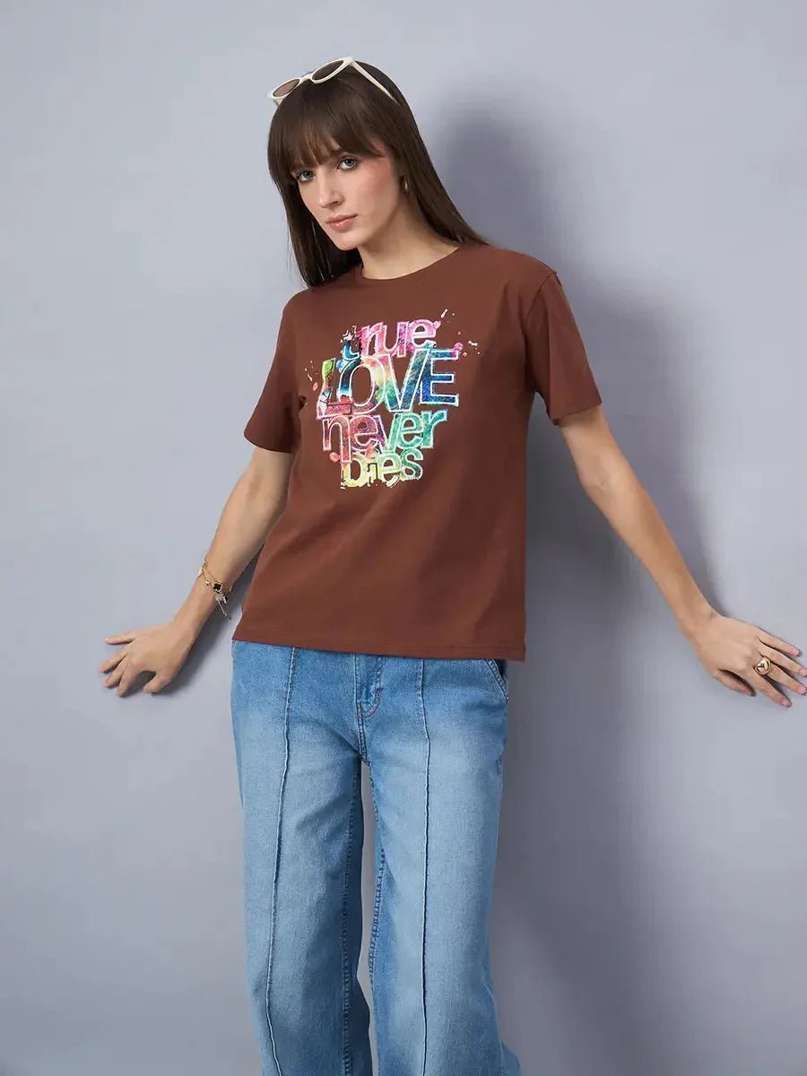 Woman in sunglasses wearing 98degreenorth Women’s Typography Graphic Print Cotton Tee, posing by a gray backdrop.