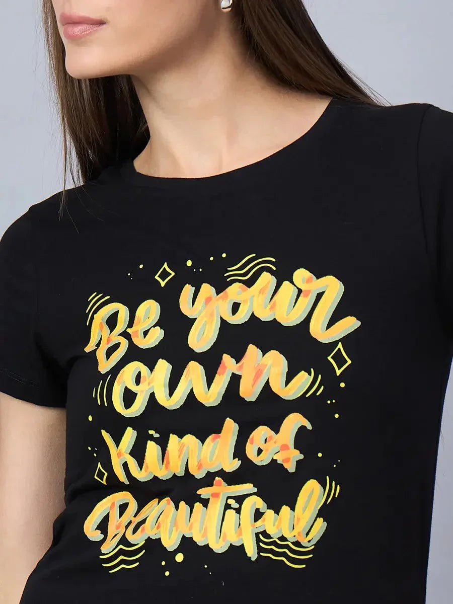 Woman in a 98degreenorth women’s typography print cotton t-shirt with “Be your own kind of beautiful” text.