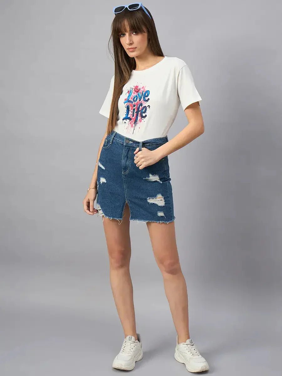 Woman in 98degreenorth Women’s Typography Printed Cotton T-shirt, denim skirt, white sneakers, and blue sunglasses.