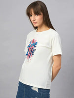 Woman wears a 98degreenorth Women’s Typography Printed Cotton T-shirt with a denim skirt, set against a gray background.