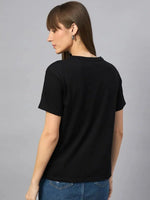 Woman with straight brown hair wears the 98degreenorth Typography Printed Cotton Tee, facing away against a plain background.