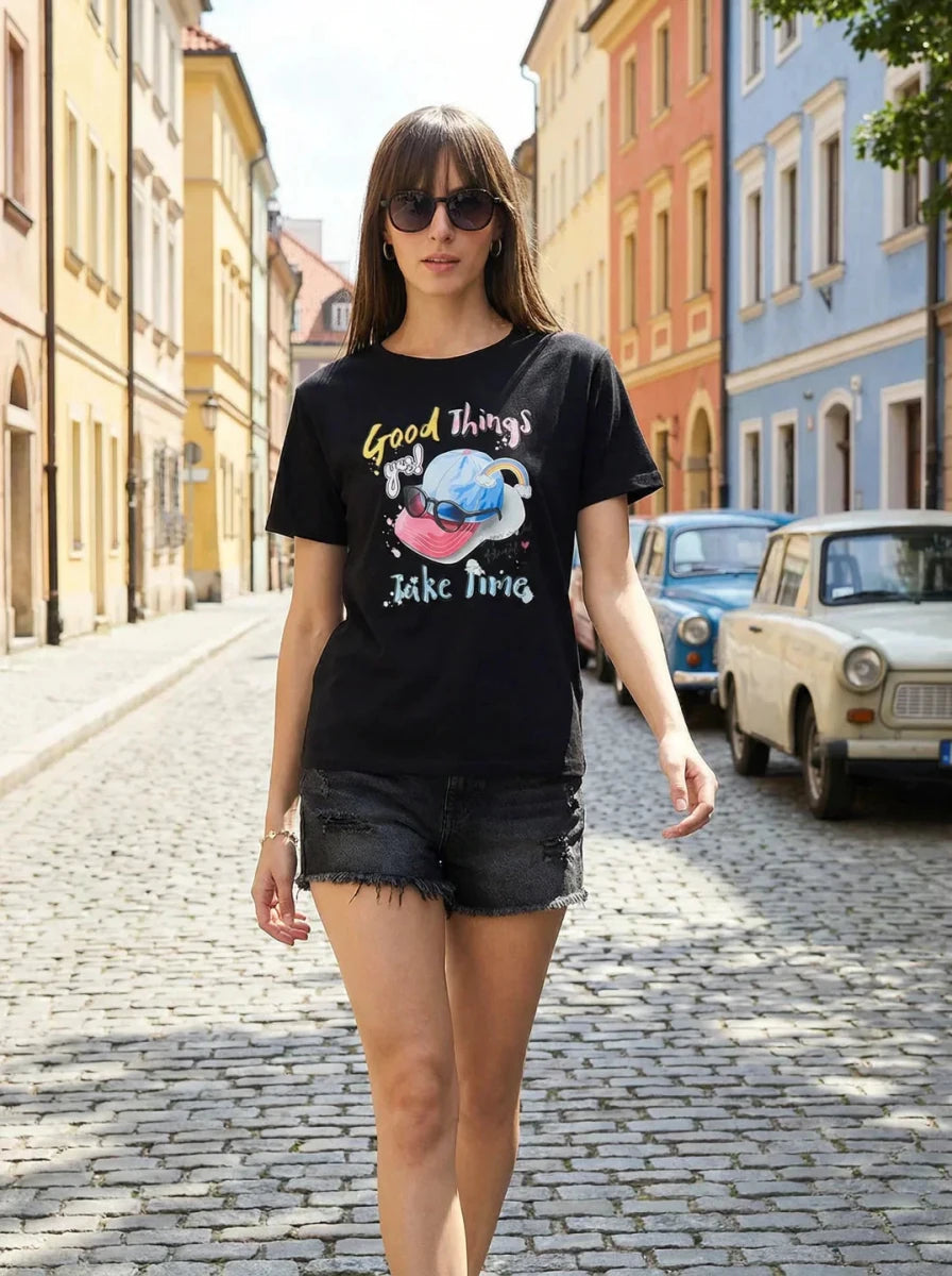 Woman in sunglasses flaunts the 98degreenorth Women’s Typography Printed Cotton Tee while strolling a vibrant street.