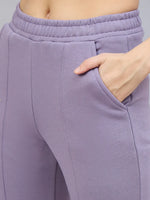 Close-up of a person in 98degreenorth Women’s Violet Flared Bootcut Sweatpants with a hand in the pocket.