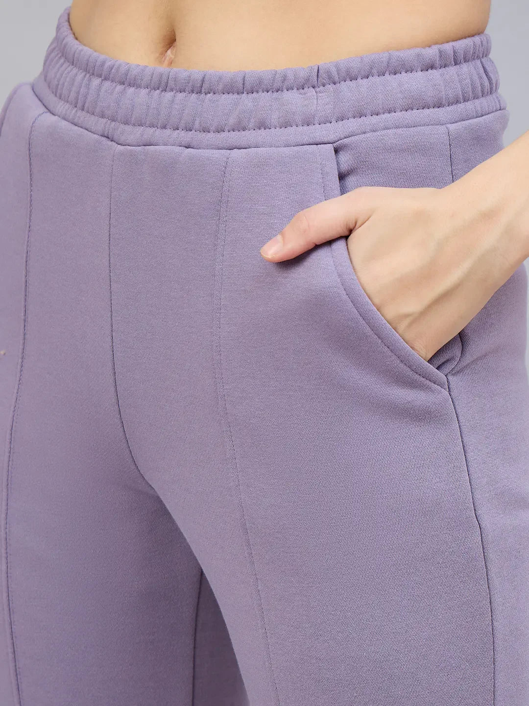 Close-up of a person in 98degreenorth Women’s Violet Flared Bootcut Sweatpants with a hand in the pocket.