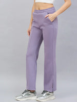Model in 98degreenorth Women’s Violet Flared Bootcut Sweatpants with Side Slit, set against a plain grey background.