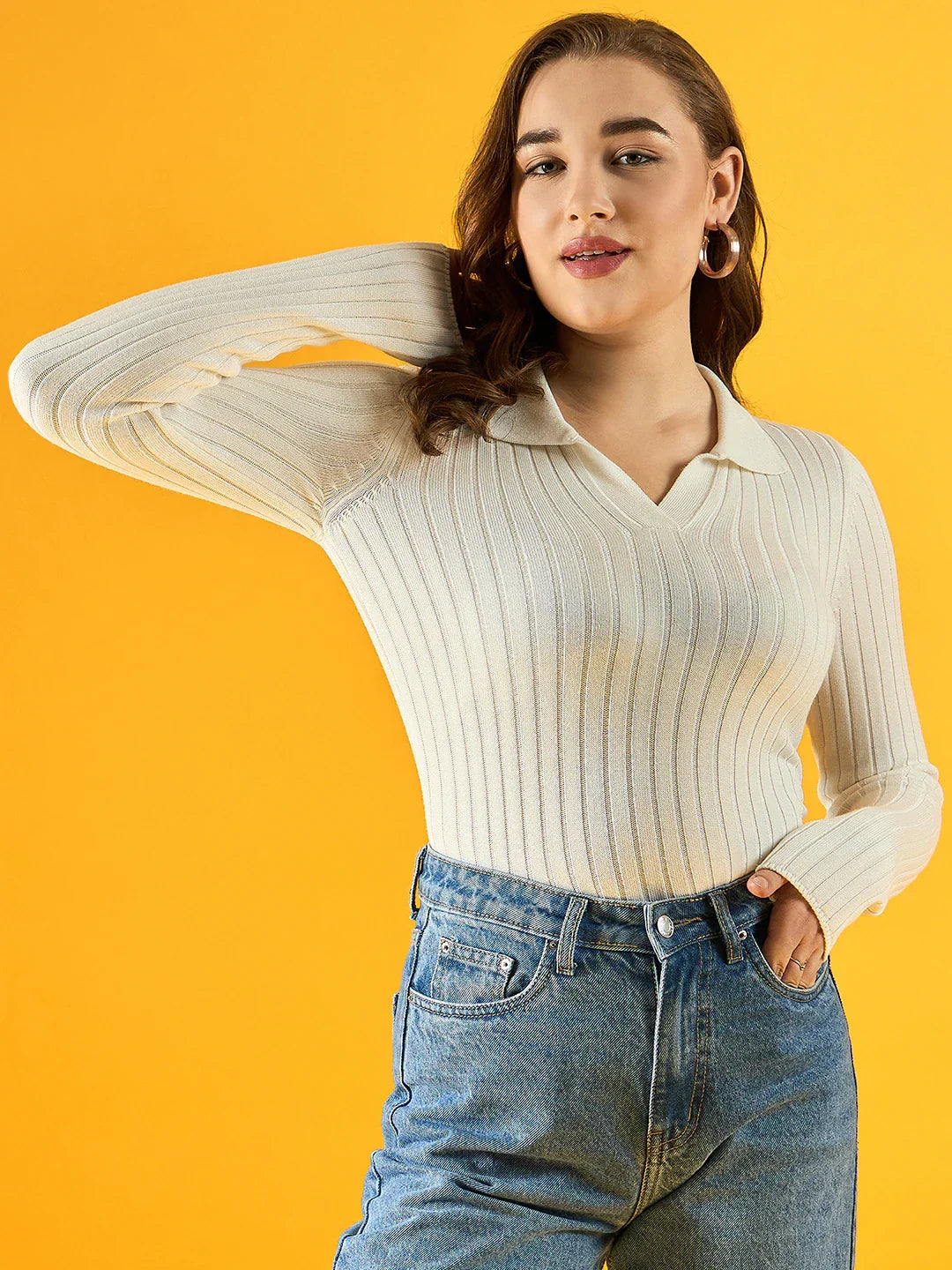 Woman wears 98degreenorth's white ribbed collar sweater, classic slim fit, posing confidently against yellow.