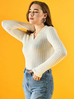 Woman wearing 98degreenorth Women’s White Ribbed Collar Neck Sweater and blue jeans poses by a yellow background.