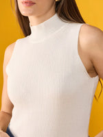 98degreenorth model wears Women’s White Ribbed High Neck Sleeveless Knit Top, a slim fit tank for summer.