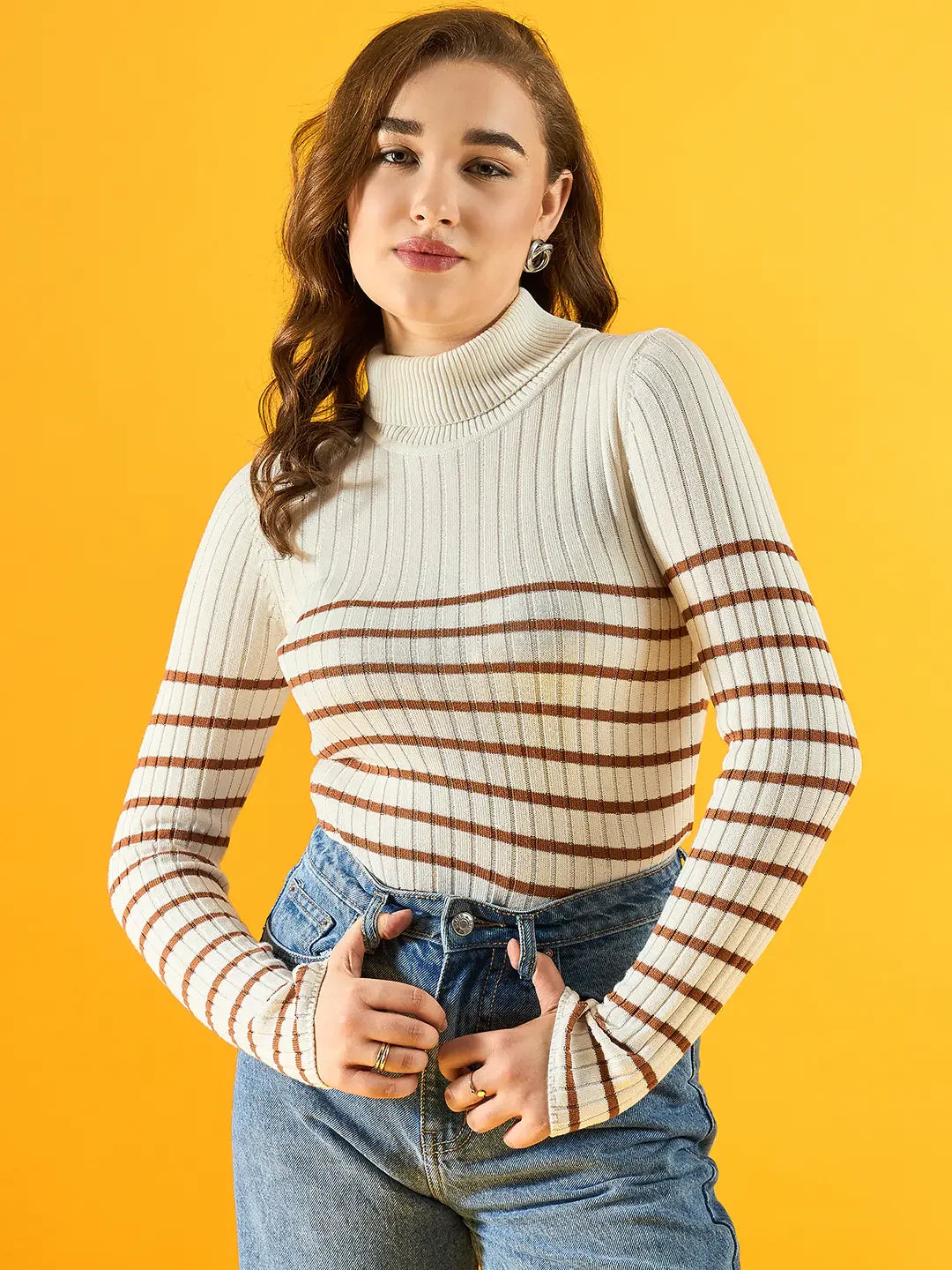 Woman in a 98degreenorth Women’s White Ribbed Striped Turtleneck Sweater poses against a bright yellow background.