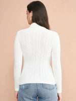 Woman wearing 98degreenorth Women's White Ribbed Turtleneck Stretchable Sweater, standing with her back to the camera.
