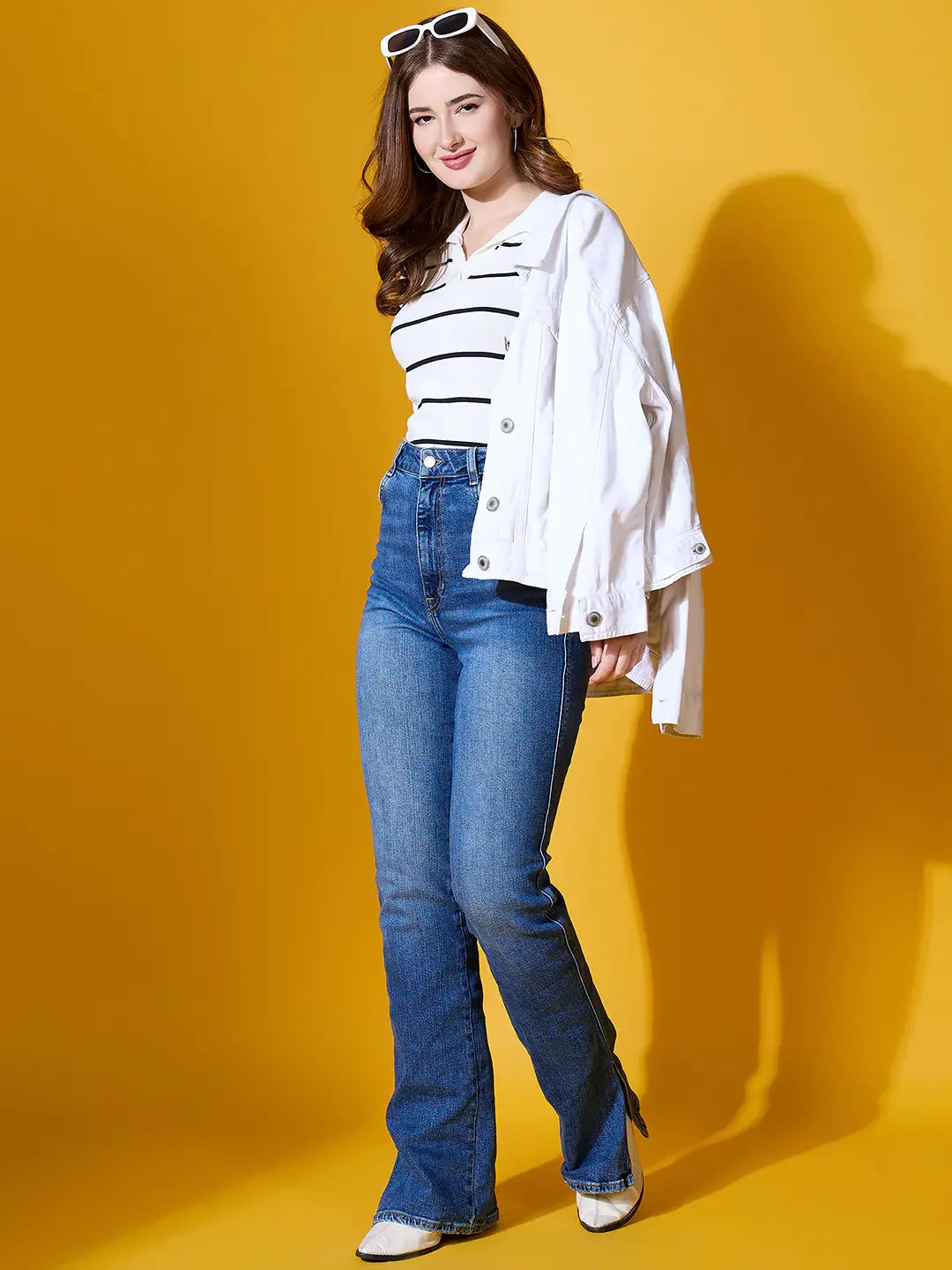 Woman wears 98degreenorth White Striped Collared Knit Sweater, posing and smiling against a yellow background.
